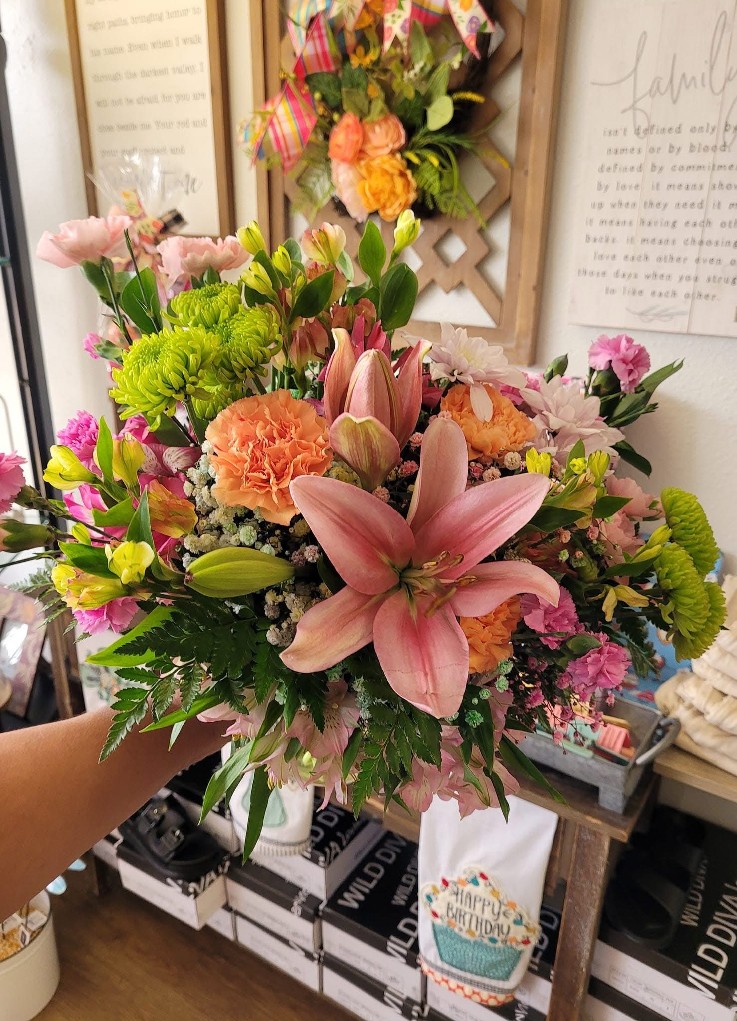 A hand-arranged peach and pink lily bouquet from The Petal Express